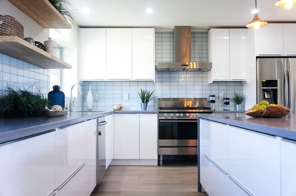 High-gloss white flat panel kitchen cabinets reflecting natural light