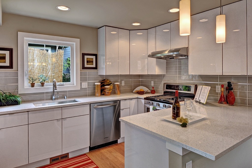 A modern kitchen showcasing sleek, handle-less flat panel cabinet doors