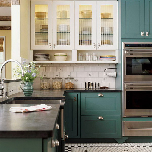 Two-tone kitchen featuring glass front cabinet doors