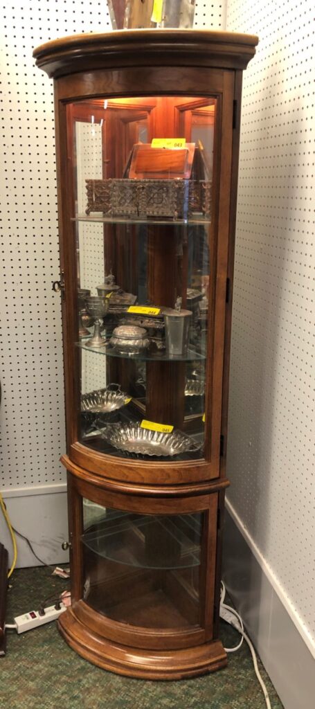 Curved glass front cabinet at island end