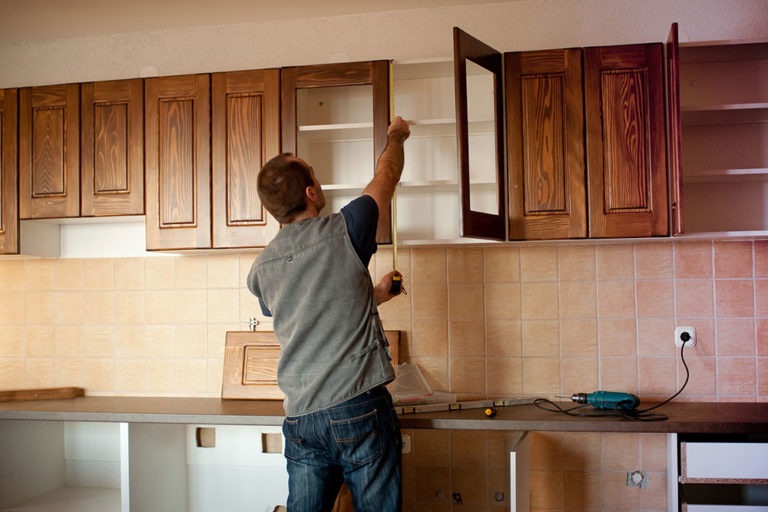 Contractor installing CARB-compliant cabinets in a modern home in California