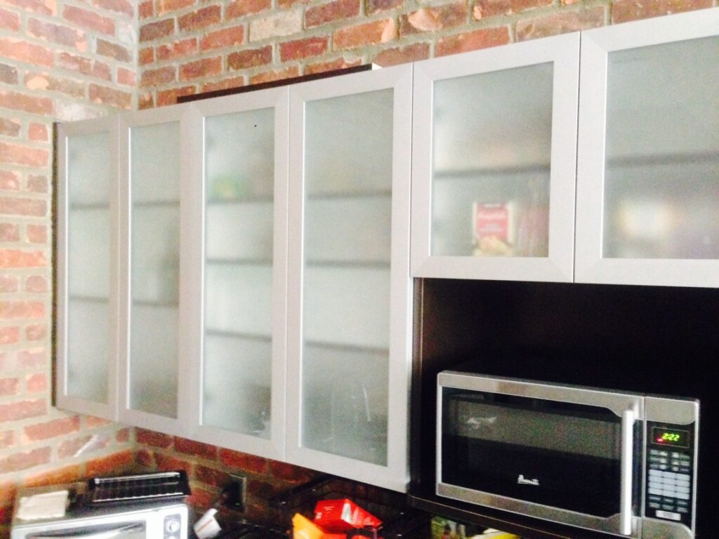 Glass-front cabinet doors with aluminum frames