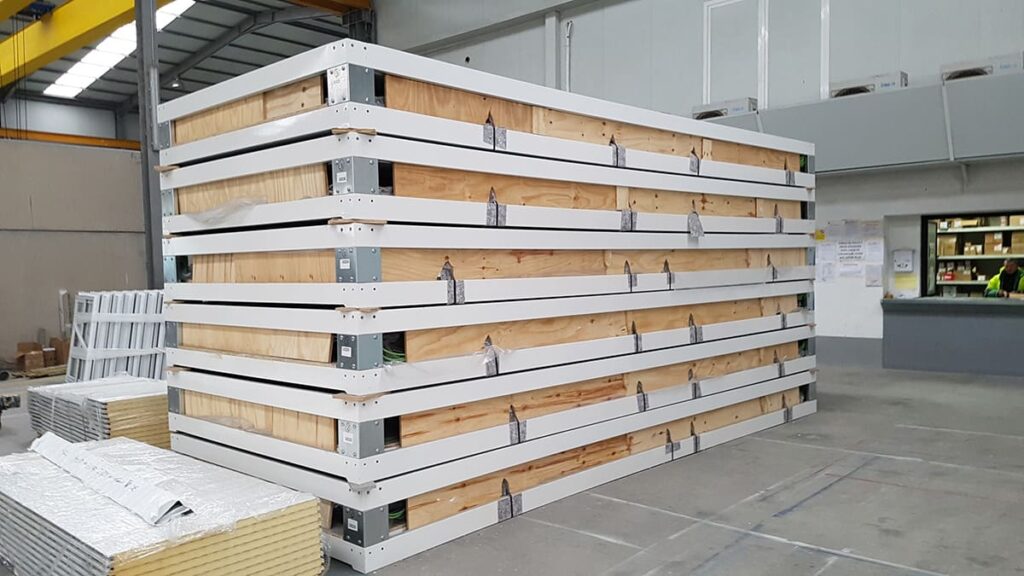 Warehouse rows stacked high with flat-pack cabinet kits awaiting bulk shipment