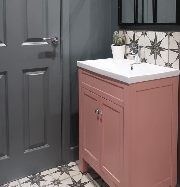 Dusty rose bathroom cabinet colors with brass accents