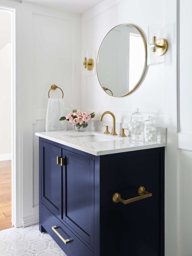 Navy bathroom cabinet colors paired with gold hardware