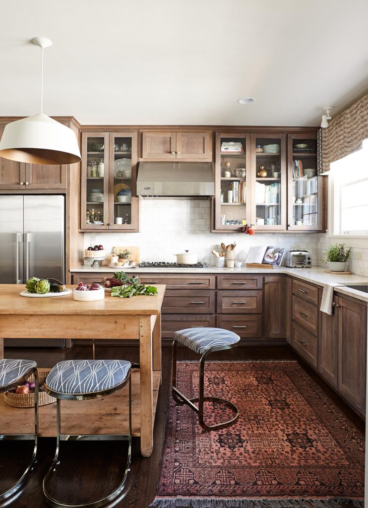 Almond cream kitchen cabinets paired with wood floors in a family kitchen