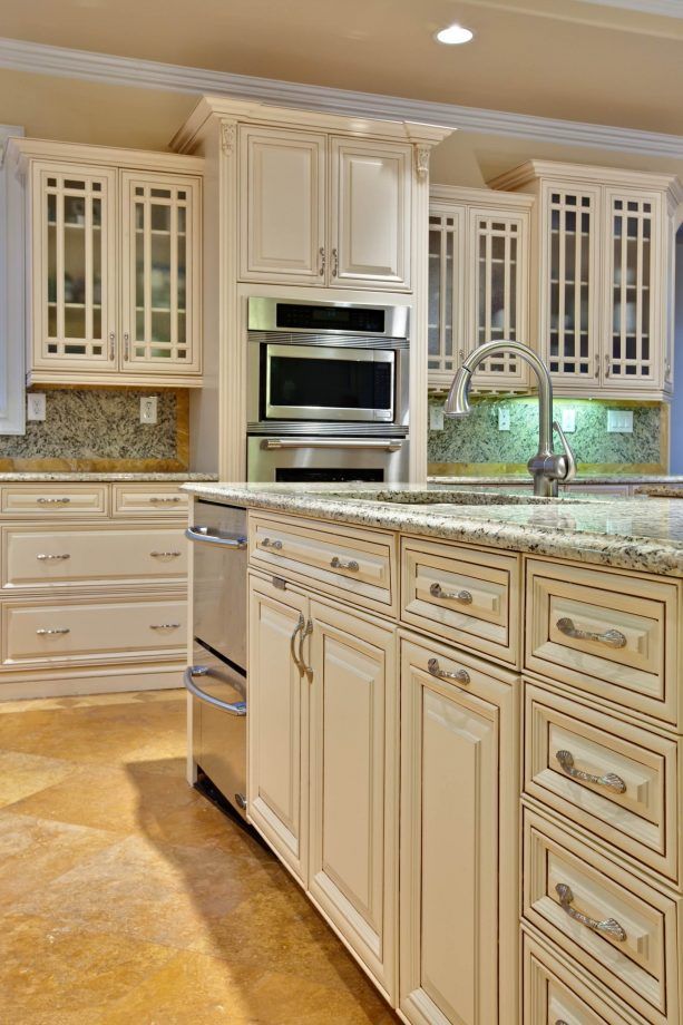 Antique cream kitchen cabinets with bronze hardware for a heritage-inspired kitchen look
