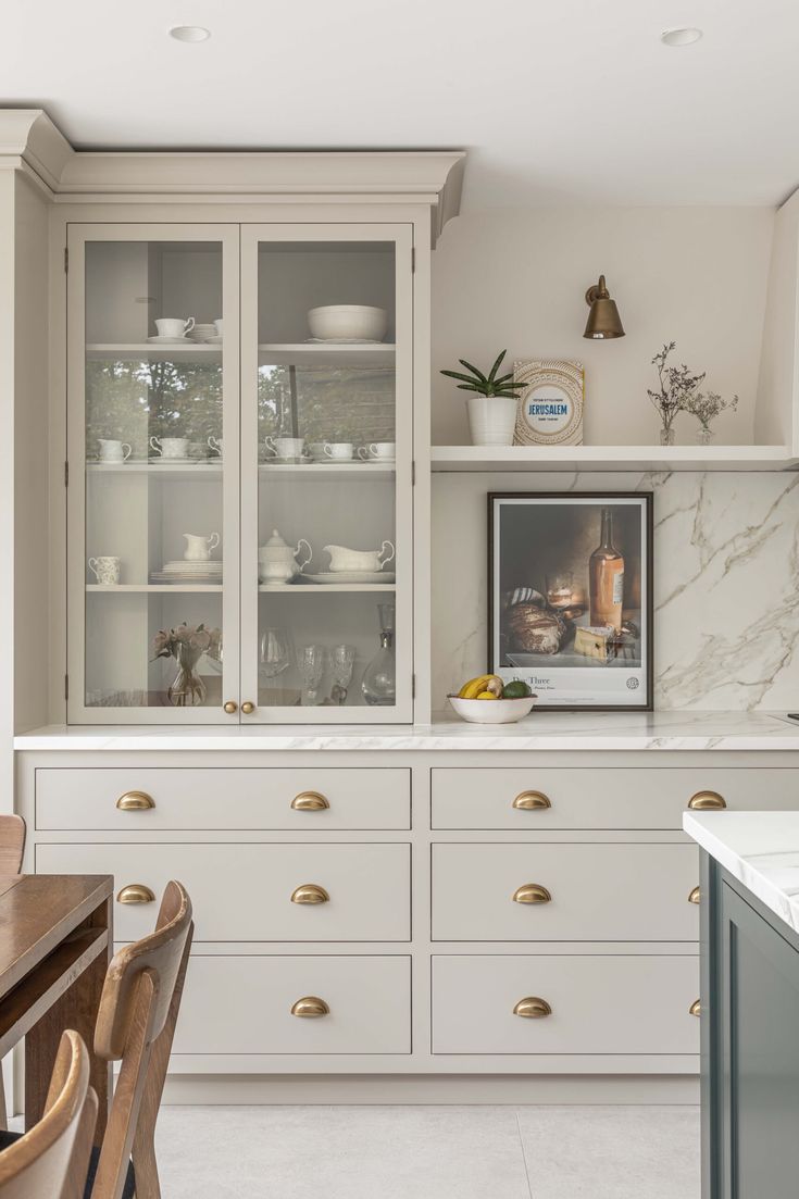 Cream beige kitchen cabinets matched with brushed nickel hardware in suburban kitchens