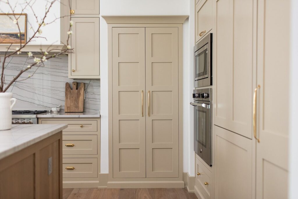 Cream beige kitchen cabinets that hide wear and maintain a clean look in suburban kitchens