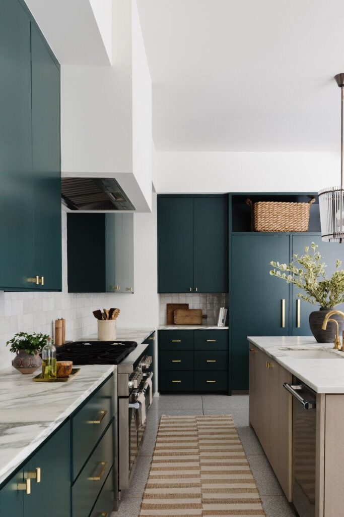 Deep green kitchen cabinet colors paired with bronze hardware for heritage design