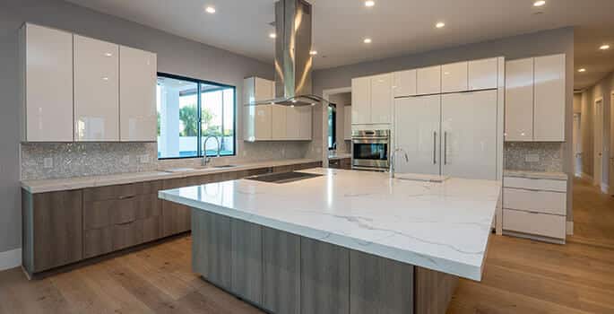 High-gloss European kitchen cabinets in white with chrome accents