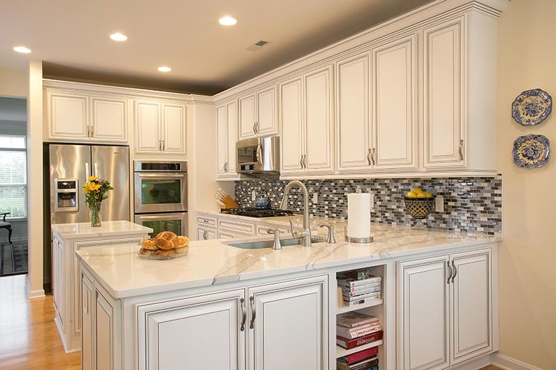 Classic kitchen featuring American style cabinets in stained oak with Shaker doors