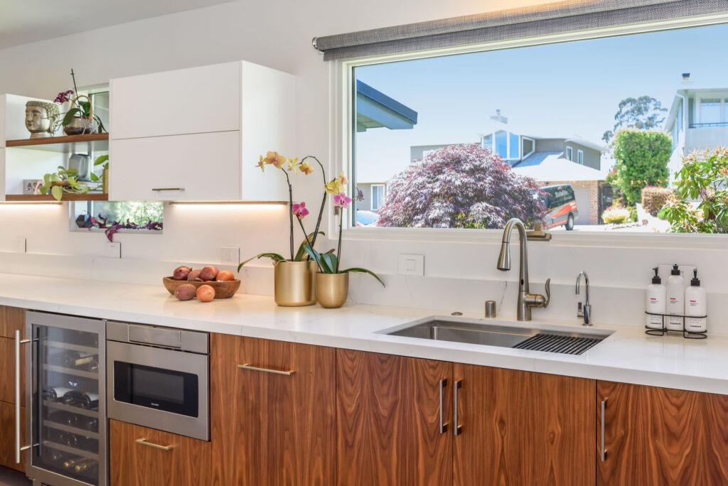 Two-tone modern kitchen featuring white and walnut cabinetry for elegant balance