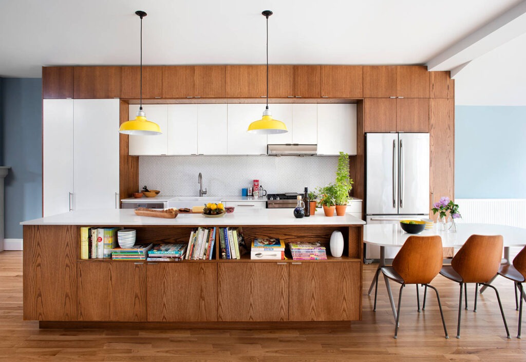 Modern kitchen showcasing oak veneer cabinets and clay accent island for a natural, grounded aesthetic