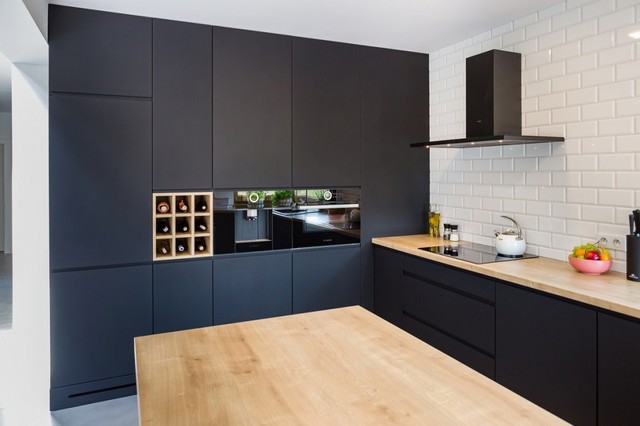 Matte black kitchen cabinets in minimalist interior