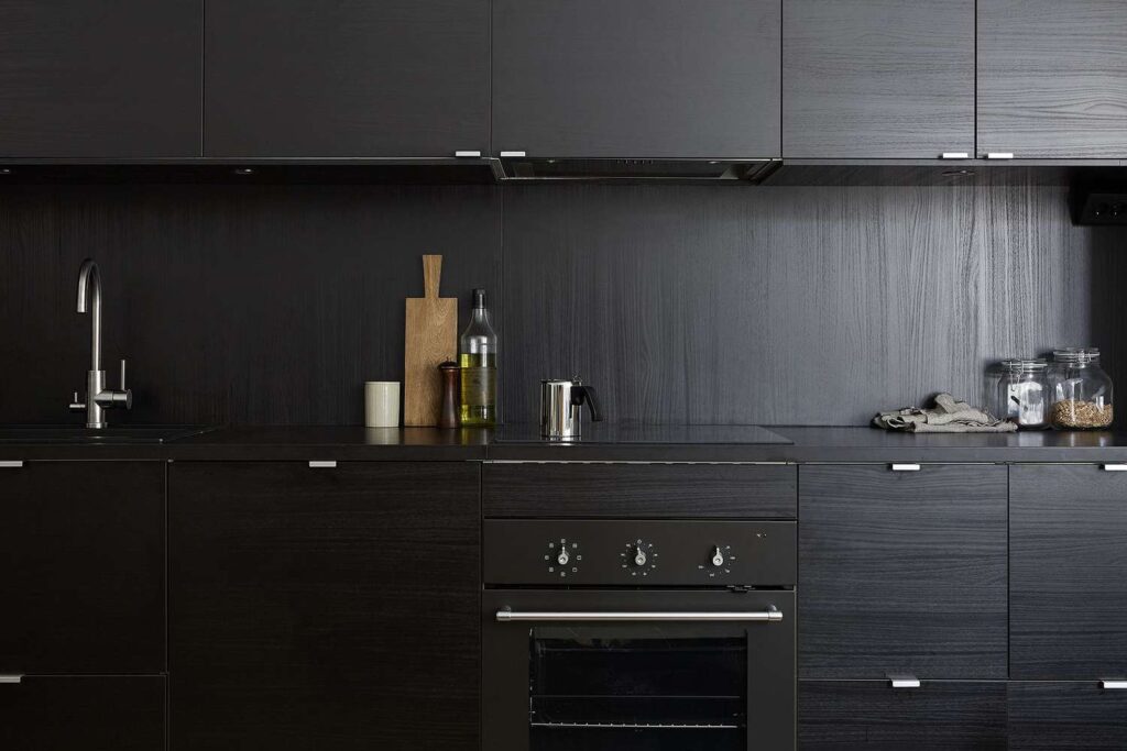 Black kitchen cabinets with concealed appliances