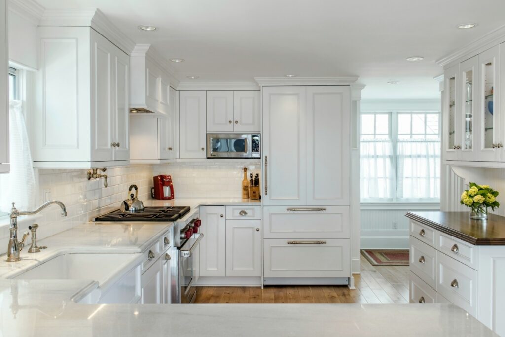 White kitchen cabinets with concealed appliances