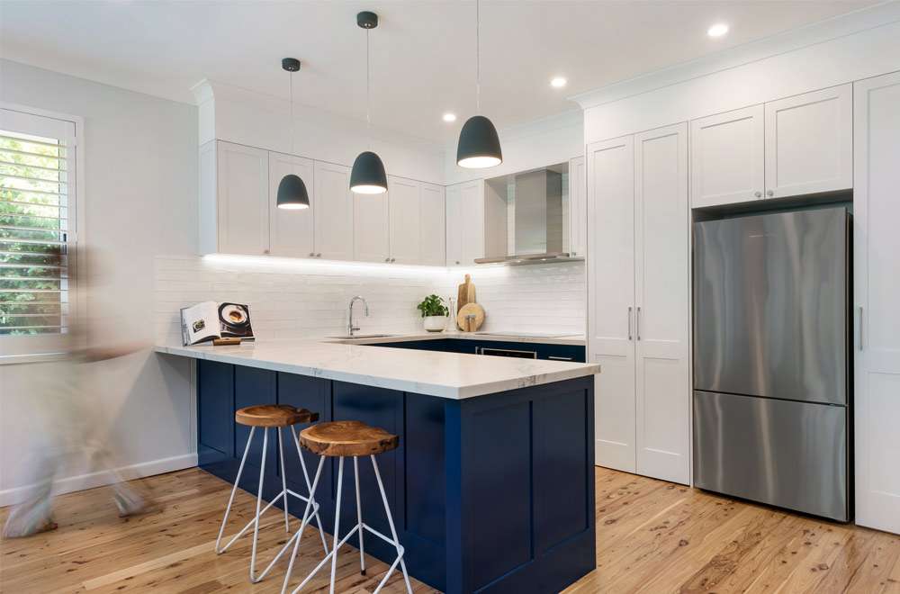 Blue and white kitchen cabinets in modern home