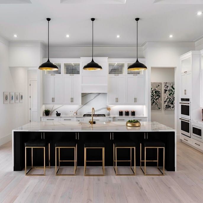 Black island with white kitchen cabinets