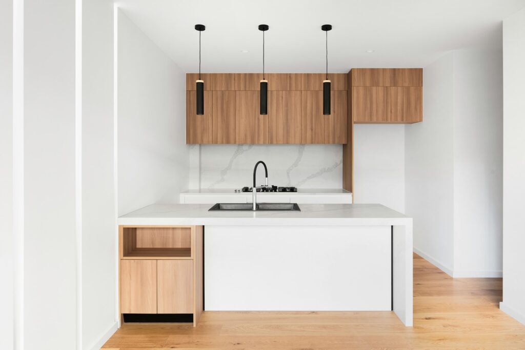 White kitchen cabinets used across multiple residential units for design consistency