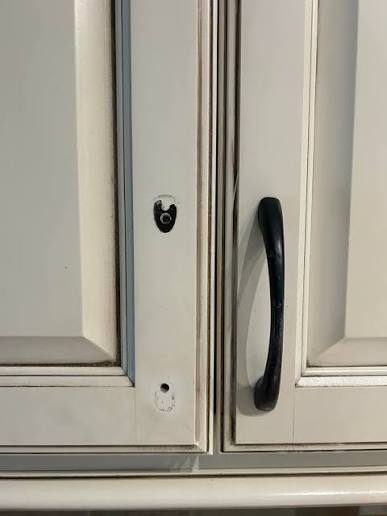 Damaged hardware mechanism commonly found in cheap kitchen cabinets