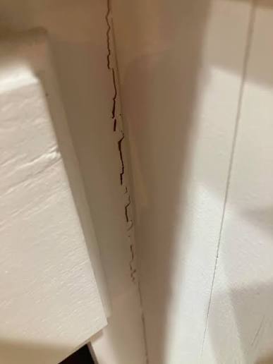 cracked corner joint typical of poorly built cheap kitchen cabinets