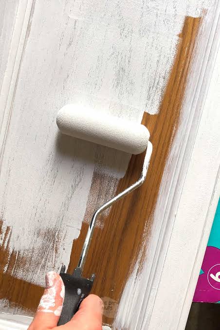 DIY latex paint application on cabinet door with roller