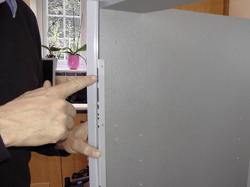 Thermofoil cabinet door edge showing heat-fused vinyl seam