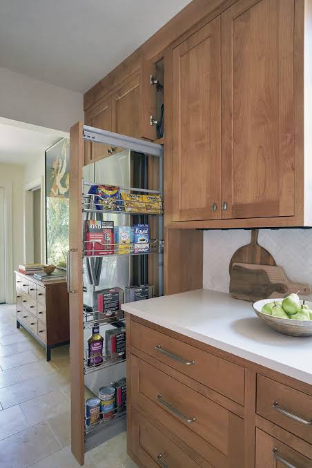 Pull-out storage configuration in galley kitchen cabinets designed for narrow layouts