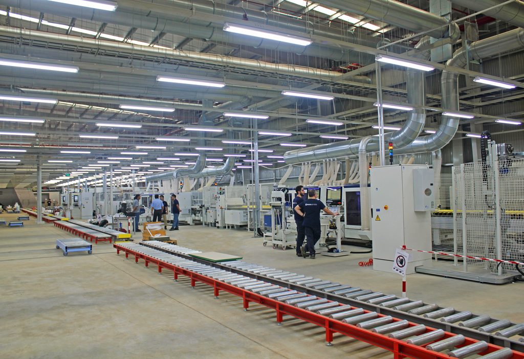 Modern cabinet factory floor with automated CNC machinery