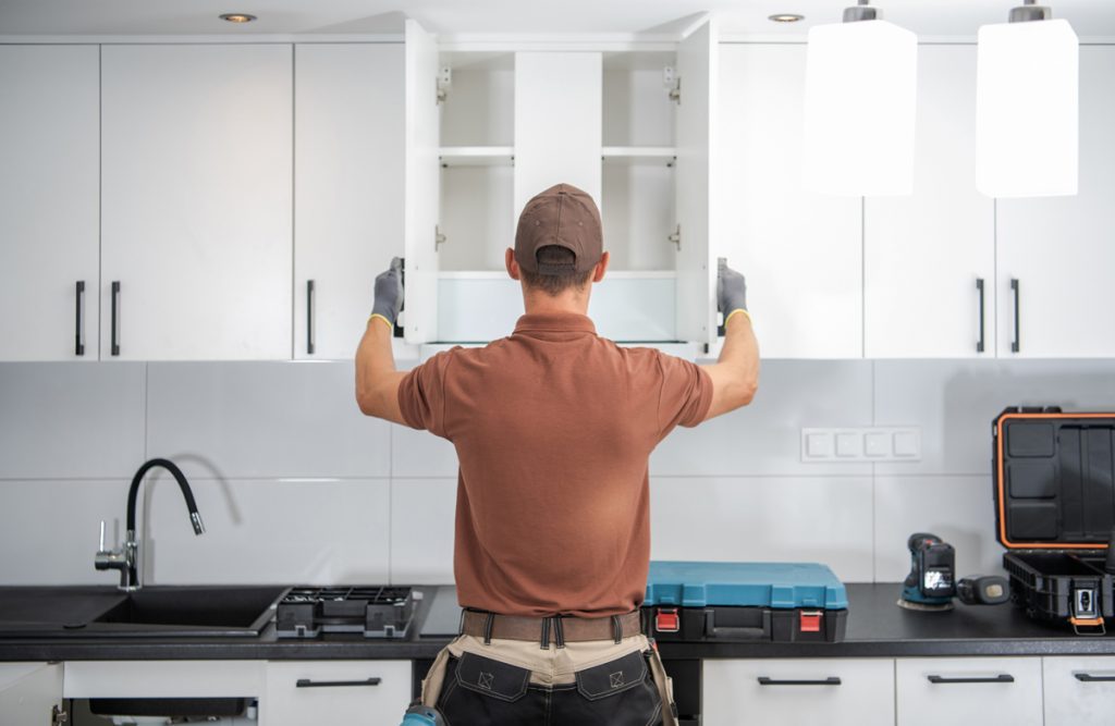 Inspector testing a cabinet drawer for smooth operation